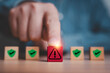© Dilok - Hand phishing red exclamation waring caution sign symbol in front of safety icon for notification error and maintenance concept.