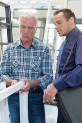 portrait of two workers checking windows