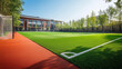 © Mahmud - 'In the school yard: a red artificial turf running track alongside a soccer field equipped with football goals.'