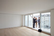 © Westend61 - Real estate agent showing balcony of new apartment to young couple