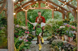 © Westend61 - Playful girl dancing with father standing at plant nursery