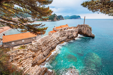 Wall Mural - Stunning coastal landscape in Petrovac, Montenegro, showcasing the old castle and rocky shoreline