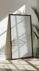 Poster - A large mirror is sitting in front of a window, with a plant behind it