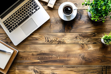 Top view of a warm wooden office desk with laptop, coffee cup, plant, and notebook, featuring ample copy space and soft lighting