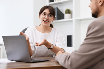 Sticker - Consultant working with client at table in office. Business meeting