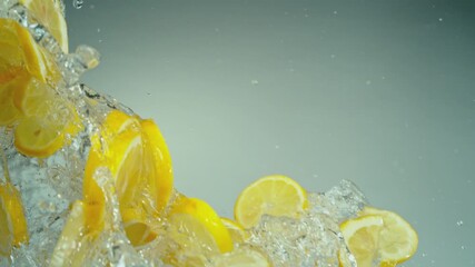 Aufkleber - Super Slow Motion of Flying Lemon Slices with Water Splashes, Isolated on Grey Background. Filmed on High Speed Cinema Camera, 1000fps. Speed Ramp Effect.