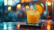 © rabbit75_fot - A glass of juice and fresh orange fruit closeup view on table in a restaurant bar