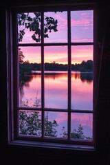 Wall Mural - A window in a serene lakeside cabin, reflecting the pink hues of a sunset over calm waters. 