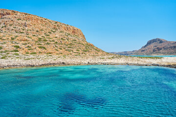 Wall Mural - Breathtaking landscape of coast of Mediterranean sea with mountains - Crete, Greece. Beautiful, clear, blue sky and water.