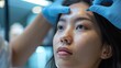 © Pat J. - Asian girl at a beauty clinic receiving a combination of cosmetic treatments for a baby face look