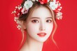 © volga - Beautiful woman with floral wreath on red background
