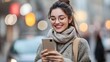 © TigerDude - Young woman using a mobile phone while walking in the city, happily smiling and looking at her smartphone screen with glasses.