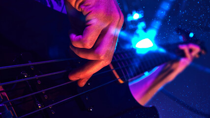 Close-up of musician's hand playing electric guitar, illuminated by vibrant blue and purple stage lights, capturing intensity of live performance. Concept of music and party, hobby and work, energy.