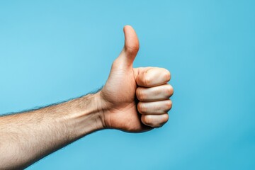 Wall Mural - Close-up of thumbs up gesture blue background