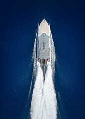 Wall Mural - aerial top down view of a catamaran jet passenger ferry boat traveling with high speed over the ocea
