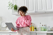 © LIGHTFIELD STUDIOS - A young woman is engaged in a lively phone conversation at home.