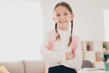 Poster - Photo of cute small schoolkid folded arms wear uniform living room apartment indoors