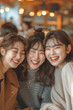 © Jirut - a happy, candid moment of a group ofyoung female friends laughing and smiling together