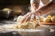 © Fxquadro - Hand pressing dough with a forceful motion.