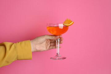 Wall Mural - Woman with glass of refreshing cocktail on pink background, closeup