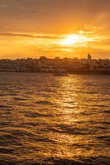 Aufkleber - The sun sets over the Bosphorus, casting golden reflections on the water