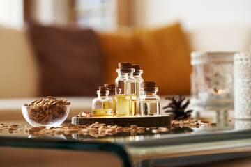 Poster - Bottles of aromatherapy essential oil with cedar wood chips and candles