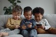 © James - Three multiethnic little boys spend time on internet sit together on sofa look at phone screen, laugh, watching funny video, use new application. tech and younger generation, bad habit, Generative AI