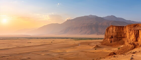  A desert landscape featuring a mountain backdrop and a road cutting through its heart