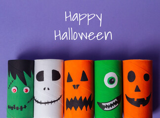 Wall Mural - A group of paper tubes with Halloween faces on them