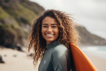 Wall Mural - Portrait of a young African American female surfer on the beach