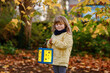 © Irina Schmidt - Little preschool kid girl holding selfmade traditional lanterns with candle for St. Martin procession. child happy about children and family parade in kindergarten. German tradition Martinsumzug