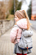 © Irina Schmidt - Cute little preschool girl going to playschool. Healthy toddler child walking to nursery school and kindergarten. Happy child with backpack on the city street, outdoors.