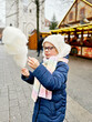 © Irina Schmidt - Little cute kid girl eats sweet cotton candy on Christmas market