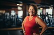 © NikoG - Smiling portrait of a slightly overweight middle aged woman in gym