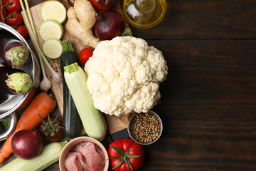 Wall Mural - Different ingredients for stew on wooden table, top view. Space for text