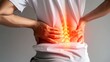 © AlfaSmart - A person arching their back slightly backward, holding the painful area with hand
