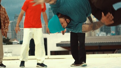 Wall Mural - Closeup of street dancer show B-boy performance surrounded by multicultural friend. Group of attractive hipster doing freeze poses at camera while wearing colorful shirt. Outdoor sport 2024. Hiphop.