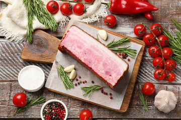 Canvas Print - Piece of raw bacon with spices and cherry tomatoes on wooden table, flat lay