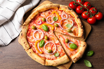 Wall Mural - Delicious vegetarian pizza and tomatoes on wooden table, flat lay