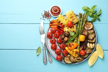 Wall Mural - Delicious grilled vegetables served on light blue wooden table, flat lay