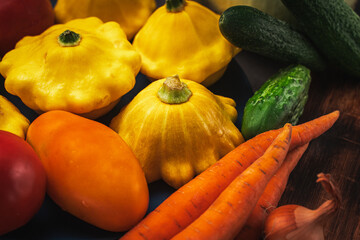 Autumn vegetables background. Organic autumn agricultural vegetables, mushrooms. Various vegetarian ingredients for preparing dinner on black kitchen background, copy space