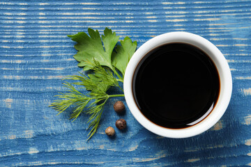 Wall Mural - Balsamic vinegar, parsley, dill and peppercorns on blue wooden table, flat lay