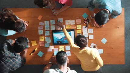 Time lapse of programmer brainstorming and planning about web design while looking at tablet wireframe prototype. Aerial view of skilled developer team talking about digital application. Symposium.