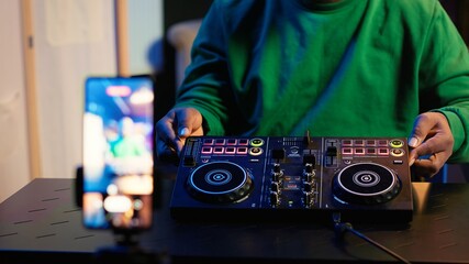 Poster - Skilled audio engineer teaching online mixing tunes lessons by using smartphone on tripod to record himself in home studio. Producer hosting a master class with soundboard console gear. Camera A.