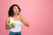 © Prostock-studio - Stay Slim. African american woman eating salad, smiling and looking at copy space isolated on white background