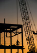 © F Armstrong Photo - Detail vertical image of large construction crane and a iron beam frame in silhouette at sunset or sunrise
