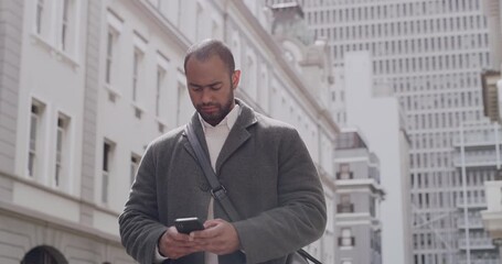 Cool, trendy businessman texting on phone, typing message or sending location on social media while walking to work in the city. Corporate man using text communication app with background copy space