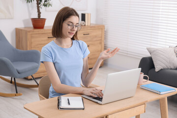 Poster - Teenager having video chat via laptop at home. Remote work