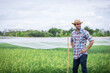 © kamonrat - Confident Farmer Standing Proudly in a Lush Green Field, Embracing Sustainable Farming Practices and Agricultural Innovation