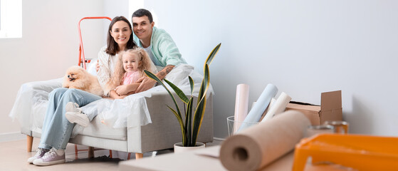 Poster - Happy family sitting on sofa during repair of their new house